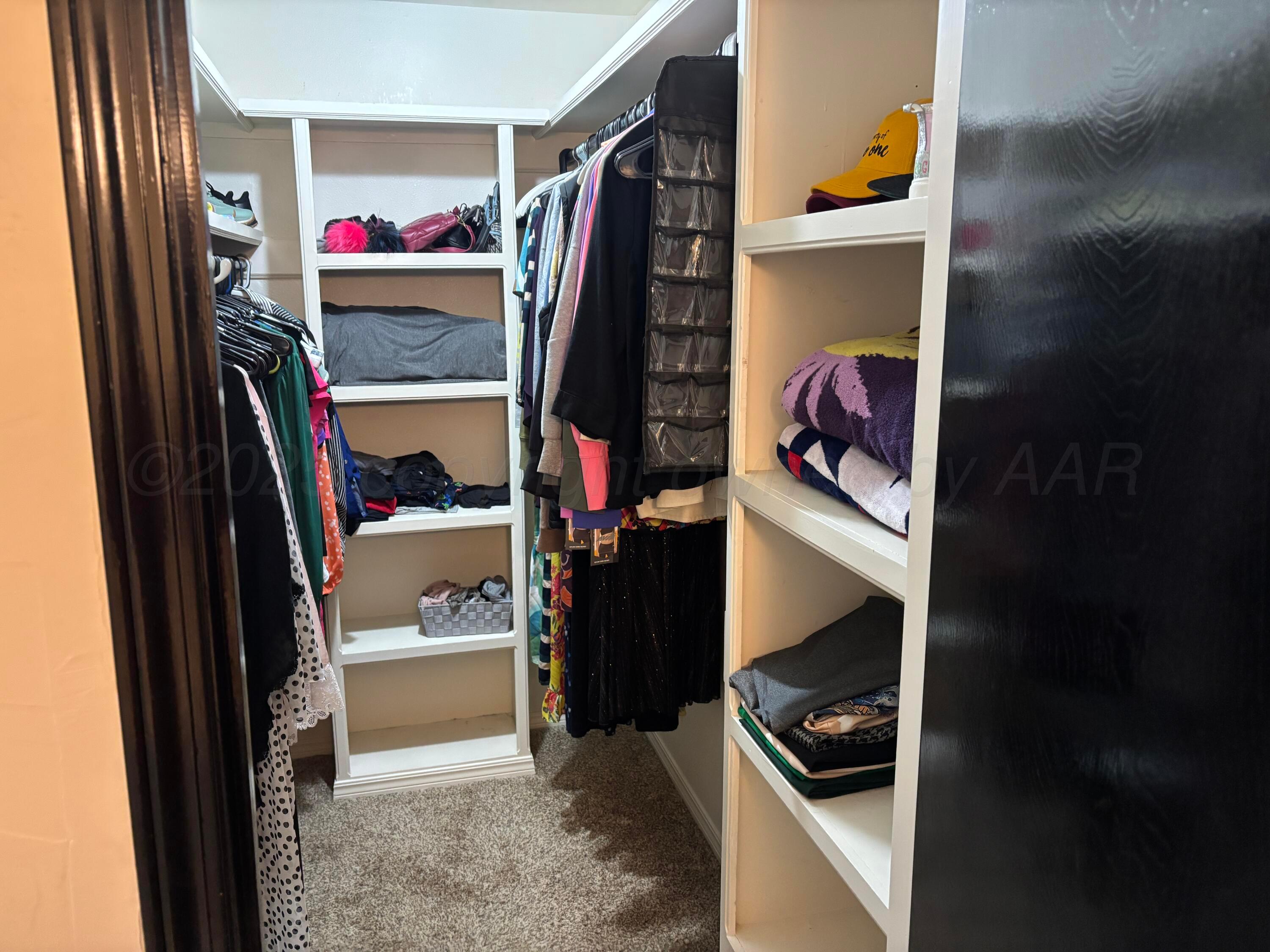 7810 Farrell Drive Amarillo, TX 79121 - Photo 28 of 31 a view of walk in closet with clothes and shoes