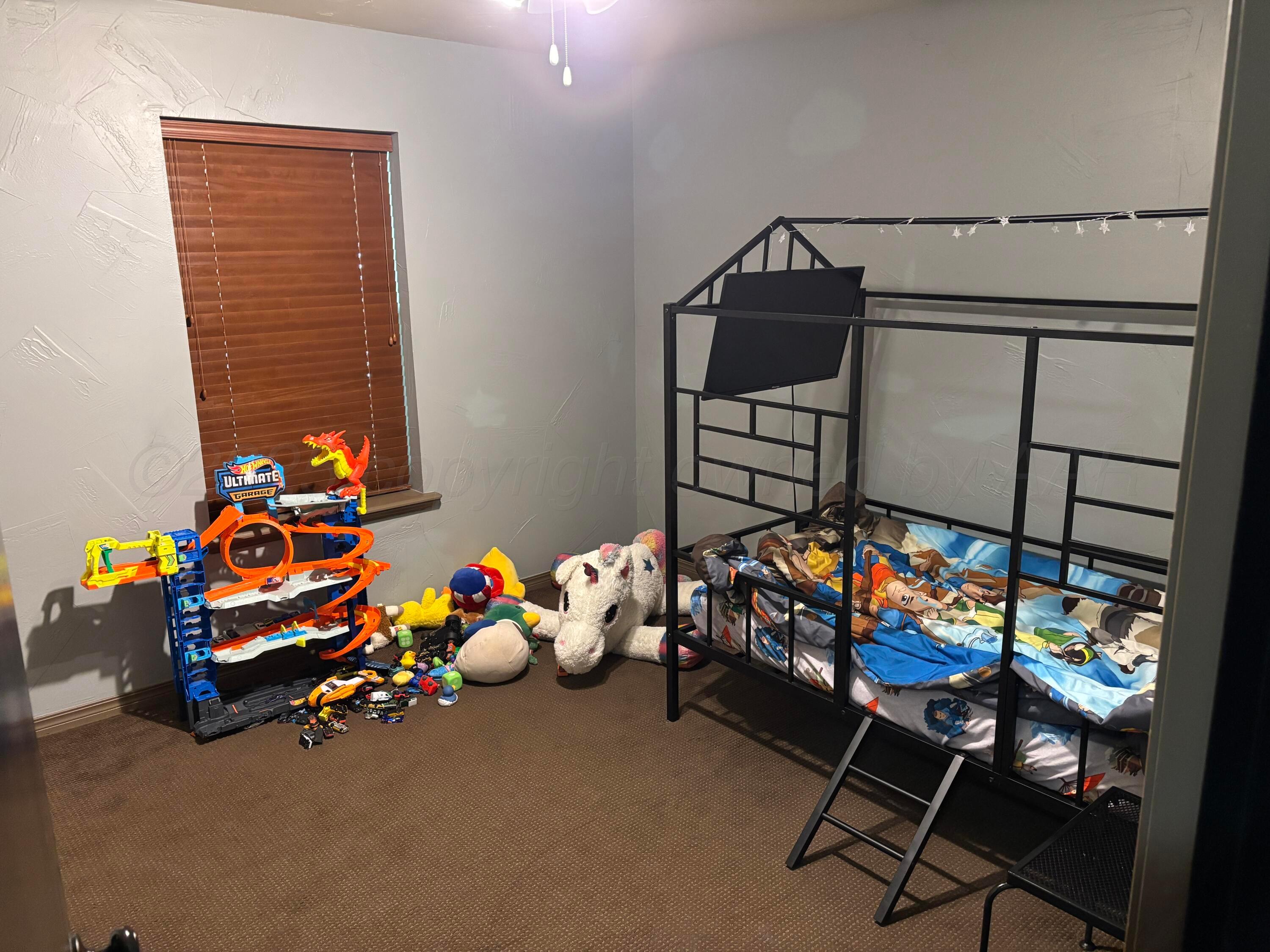 7810 Farrell Drive Amarillo, TX 79121 - Photo 9 of 31 a bedroom with bunk beds and a chair