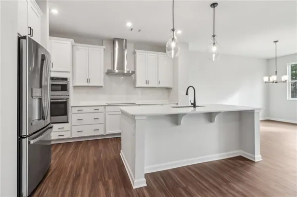 a kitchen with stainless steel appliances a refrigerator sink and cabinets