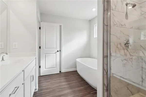 a bathroom with double vanity sinks and a mirror
