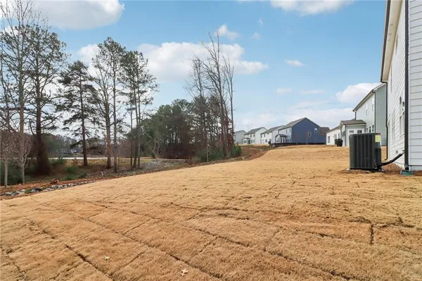 a view of a house with a backyard