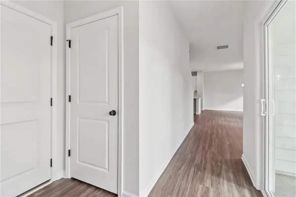 a view of a hallway with wooden floor