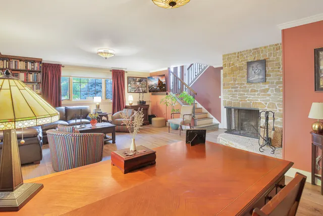 a living room with furniture a rug and a fireplace
