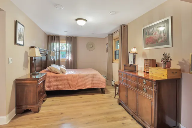a bedroom with a bed and wooden furniture