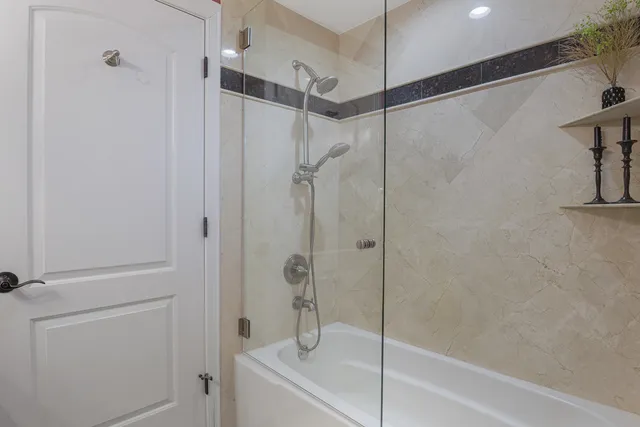 a bathroom with a shower and a bath tub