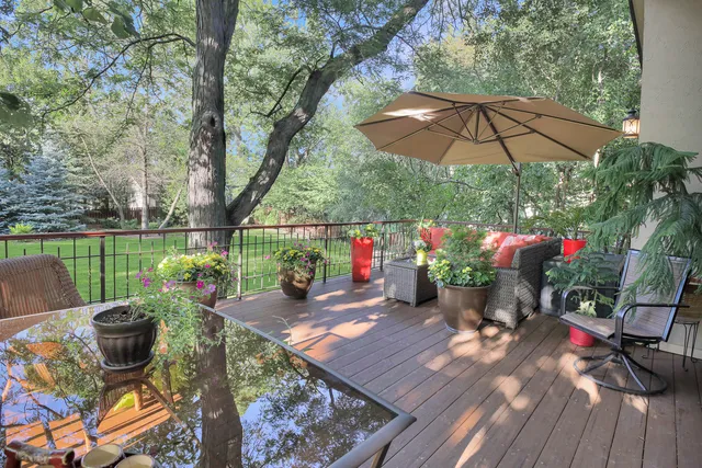 a view of a chairs and table in the patio with a garden