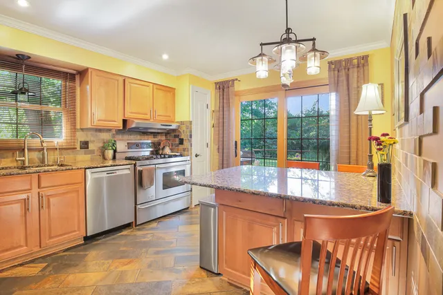 a kitchen with a stove a sink and a refrigerator
