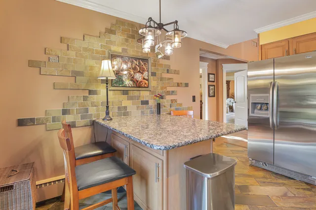 a kitchen with kitchen island a counter top space a sink and cabinets