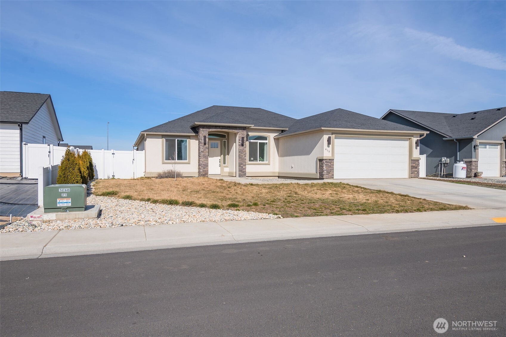 415 R Street Southwest Quincy, WA 98848 - Photo 30 of 33 a front view of a house with a yard and garage