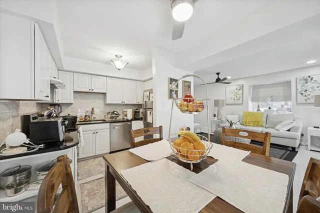 a living room with furniture and a kitchen view