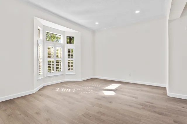a view of an empty room and wooden floor
