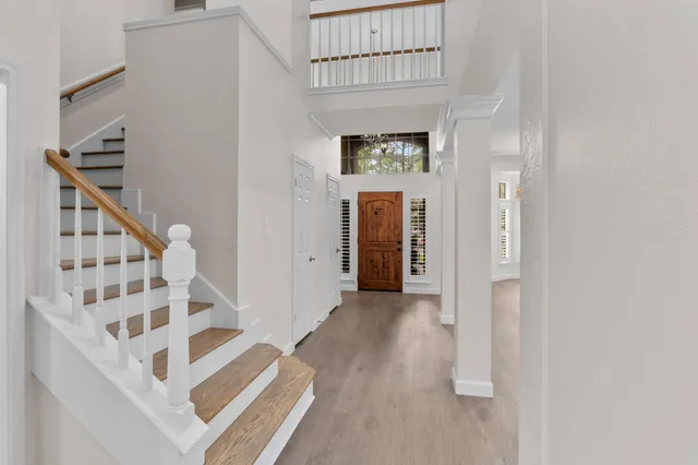 an empty room with a cabinet and mirrors