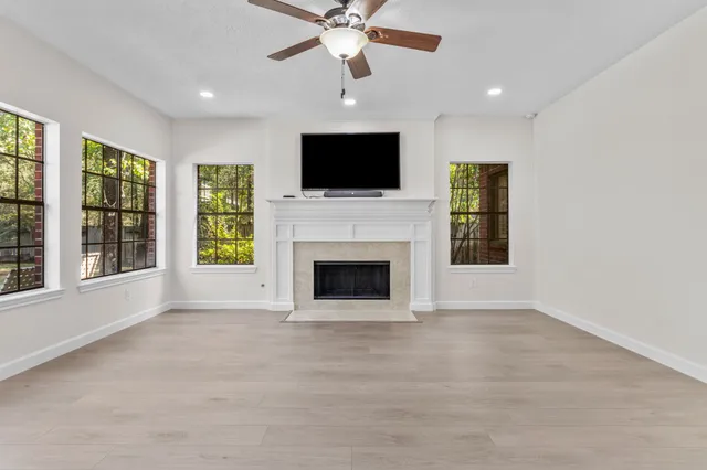 a living room with furniture fireplace and flat screen tv
