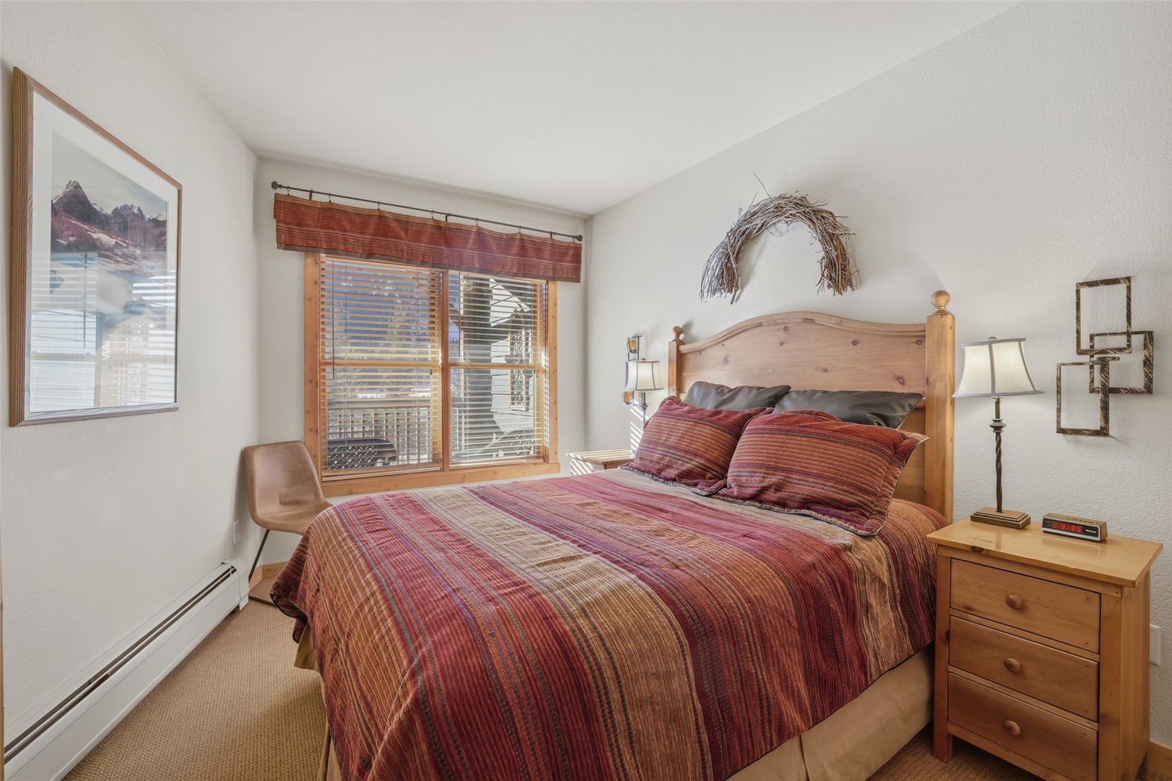 22784 Highway 6, Unit 2628 Keystone, CO 80435 - Photo 17 of 45 a bedroom with a bed and wooden floor