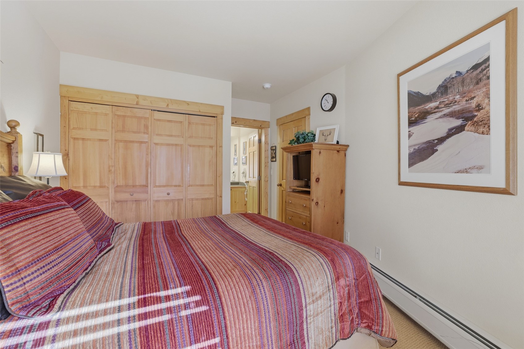 22784 Highway 6, Unit 2628 Keystone, CO 80435 - Photo 18 of 45 a bedroom with a bed and a painting on the wall
