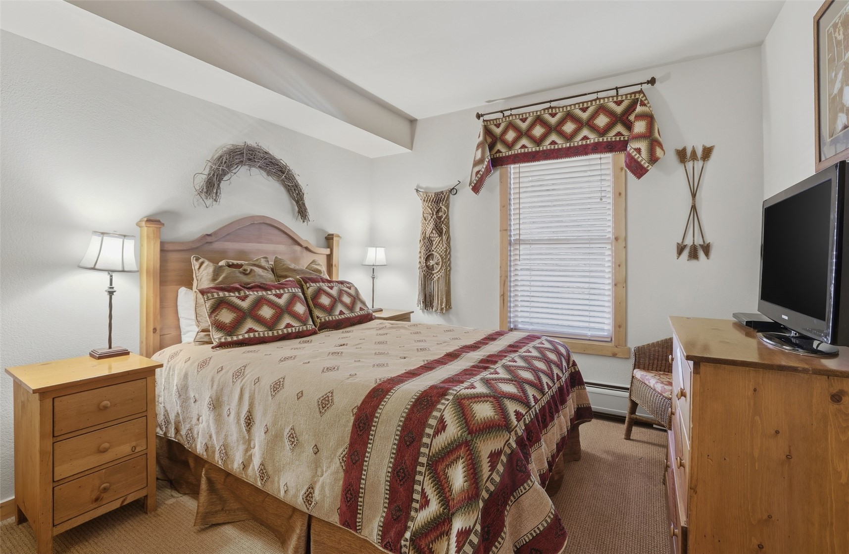 22784 Highway 6, Unit 2628 Keystone, CO 80435 - Photo 21 of 45 a bedroom with a bed and a flat screen tv