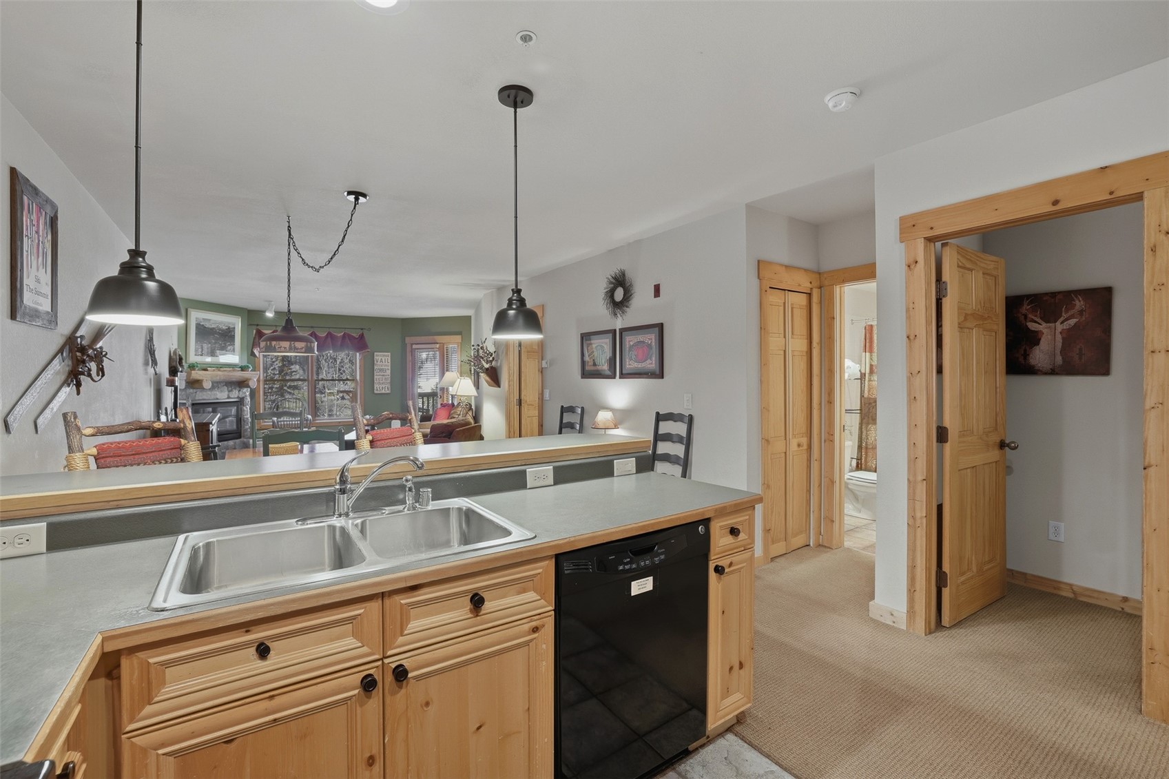 22784 Highway 6, Unit 2628 Keystone, CO 80435 - Photo 8 of 45 a kitchen with stainless steel appliances granite countertop a sink a refrigerator and a wooden floor
