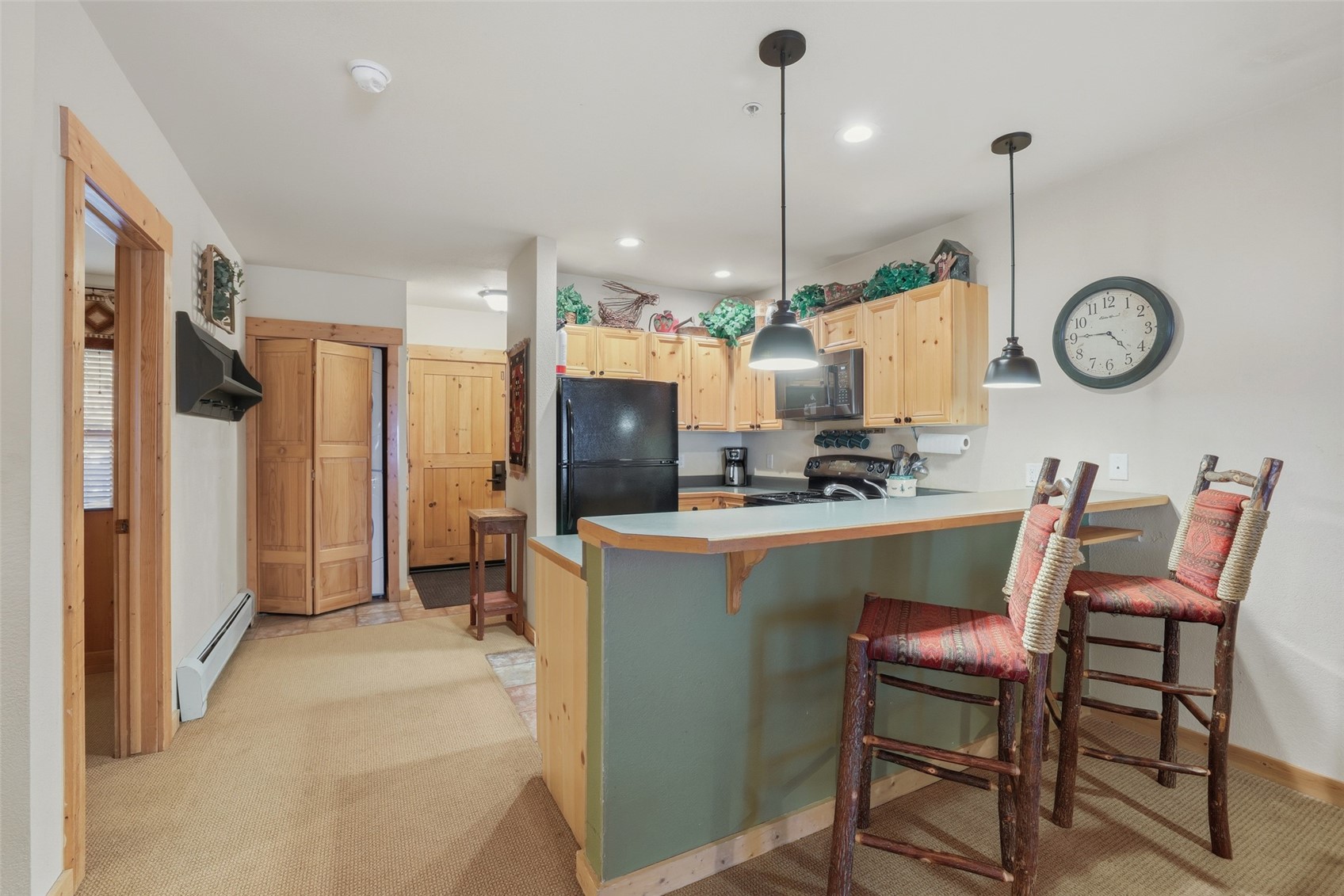 22784 Highway 6, Unit 2628 Keystone, CO 80435 - Photo 9 of 45 a kitchen with stainless steel appliances kitchen island granite countertop a table chairs and a refrigerator
