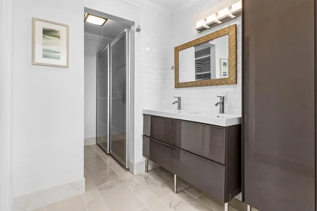 an aerial view of residential houses with outdoor space and lake view