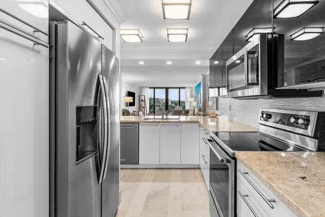 a dining room with furniture a rug and a floor to ceiling window