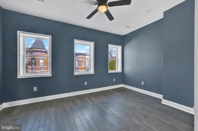 a view of room with hardwood floor and windows