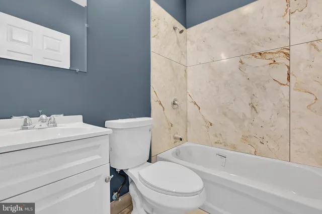 a bathroom with a sink a toilet and a bathtub