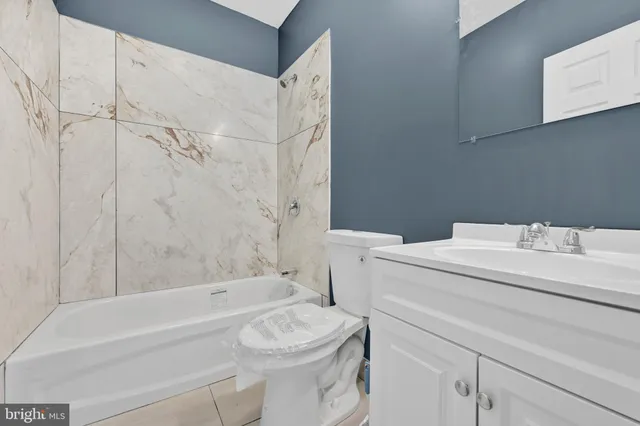 a bathroom with a sink a toilet and a bathtub