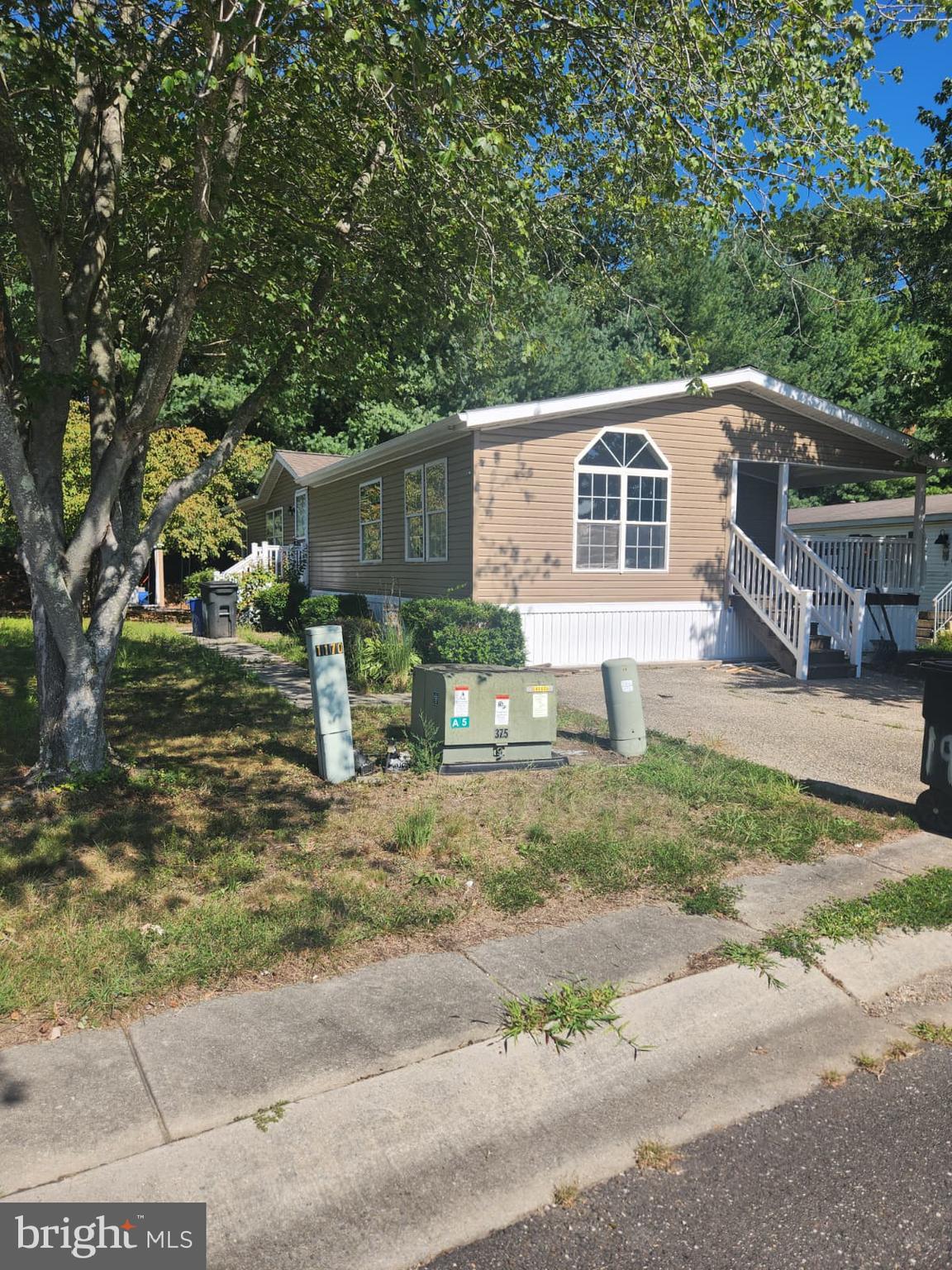 2110 Mays Landing Road, Unit 199 Millville, NJ 08332 - Photo 1 of 18 a front view of a house with garden