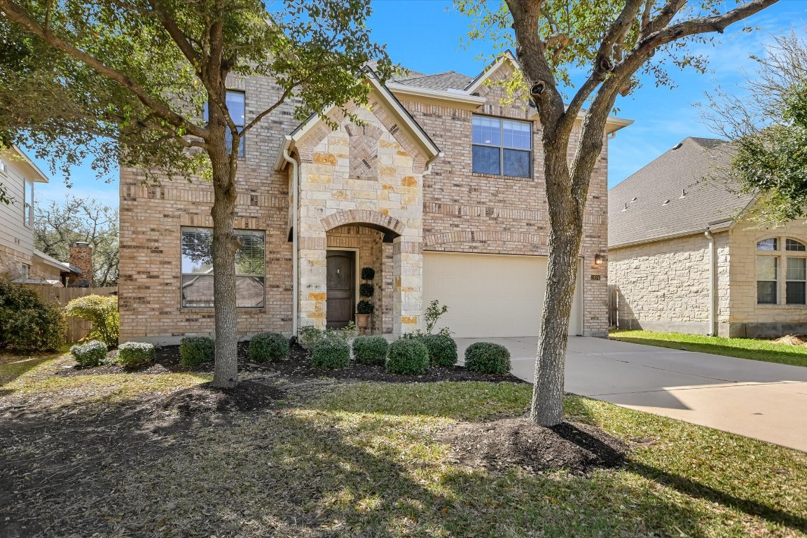 1874 Nelson Ranch Loop Cedar Park, TX 78613 - Photo 1 of 30 a front view of a house with garden