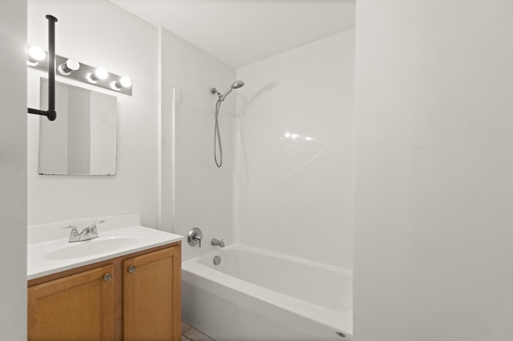 145 Lewis Street Lynn, MA 01902 - Photo 13 of 32 a bathroom with a sink a toilet and shower