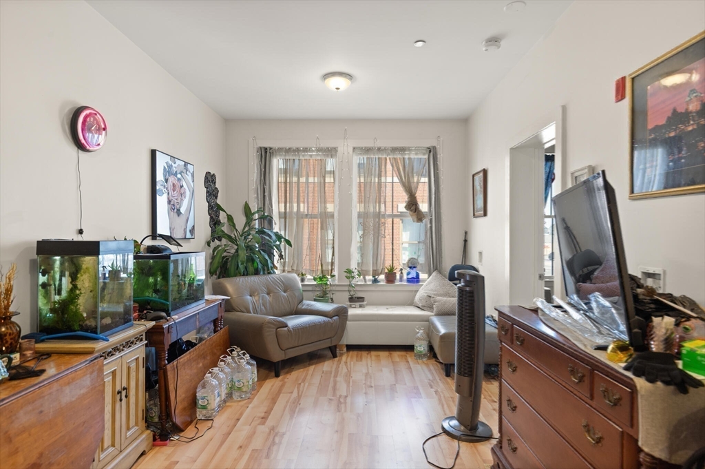 145 Lewis Street Lynn, MA 01902 - Photo 16 of 32 a living room with furniture a window and a flat screen tv