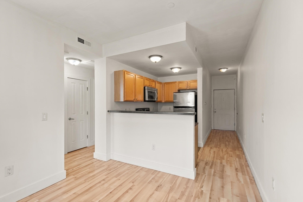 145 Lewis Street Lynn, MA 01902 - Photo 17 of 32 a view of kitchen with cabinets and wooden floor