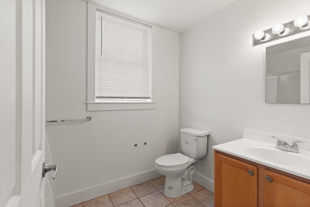 145 Lewis Street Lynn, MA 01902 - Photo 20 of 32 a white toilet sitting next to a bathroom sink