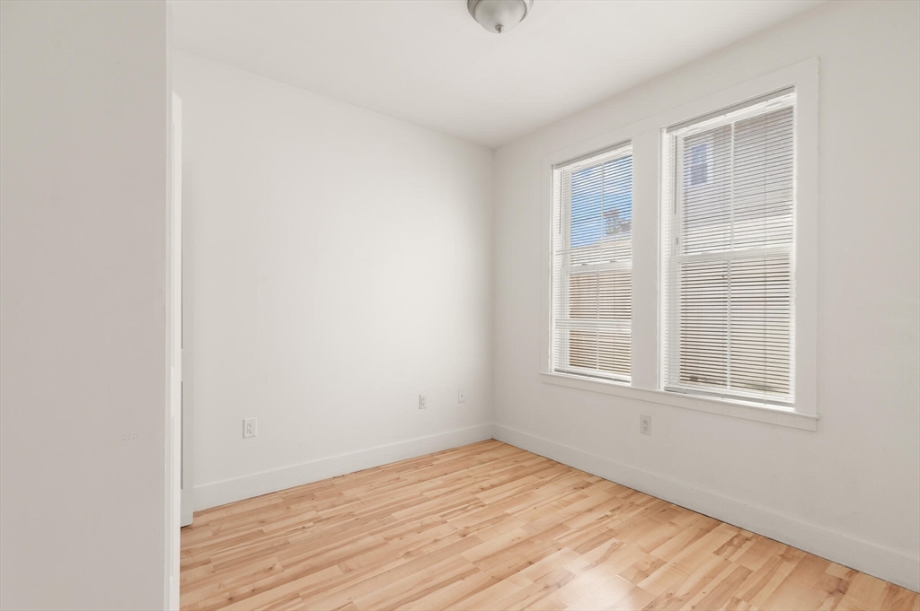 145 Lewis Street Lynn, MA 01902 - Photo 23 of 32 an empty room with wooden floor and windows