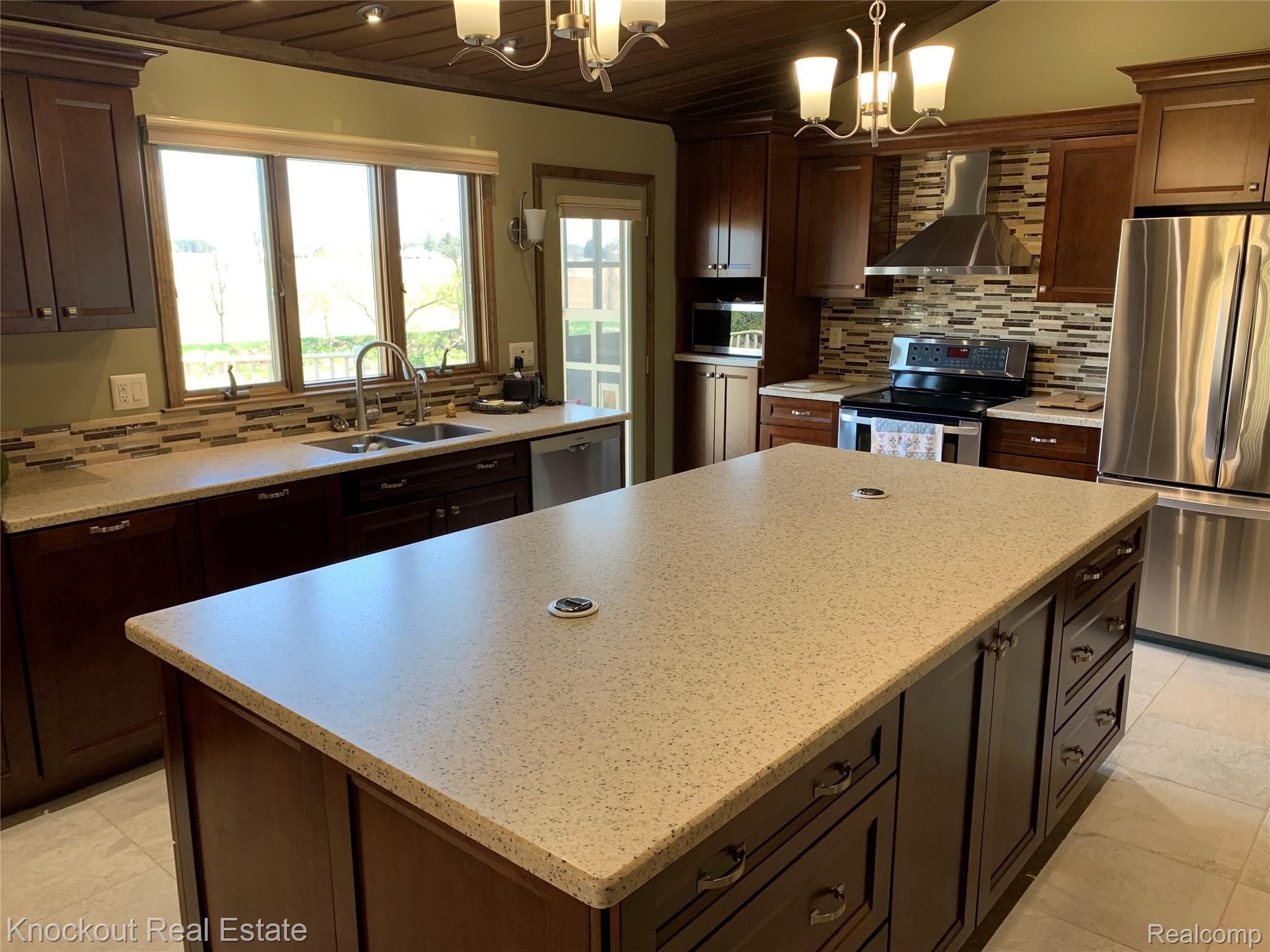 9252 Ormes Road Vassar, MI 48768 - Photo 11 of 64 Corion countertops with stainless steel appliances that stay