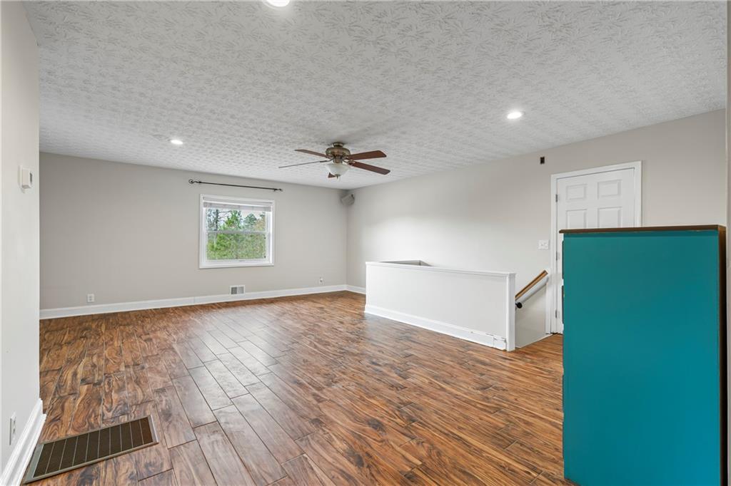2150 Smyrna Ridge Court Southwest Conyers, GA 30094 - Photo 39 of 125 a view of an empty room with a window and wooden floor