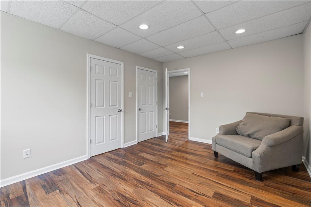 2150 Smyrna Ridge Court Southwest Conyers, GA 30094 - Photo 59 of 125 a living room with furniture and a wooden floor