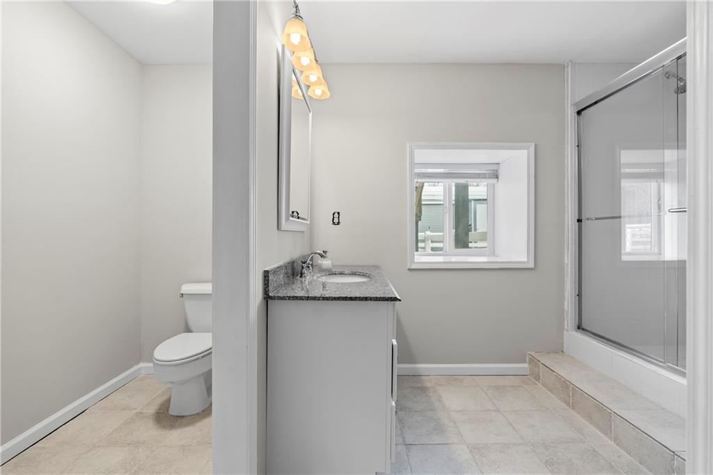 2150 Smyrna Ridge Court Southwest Conyers, GA 30094 - Photo 60 of 125 a bathroom with a granite countertop toilet and a sink