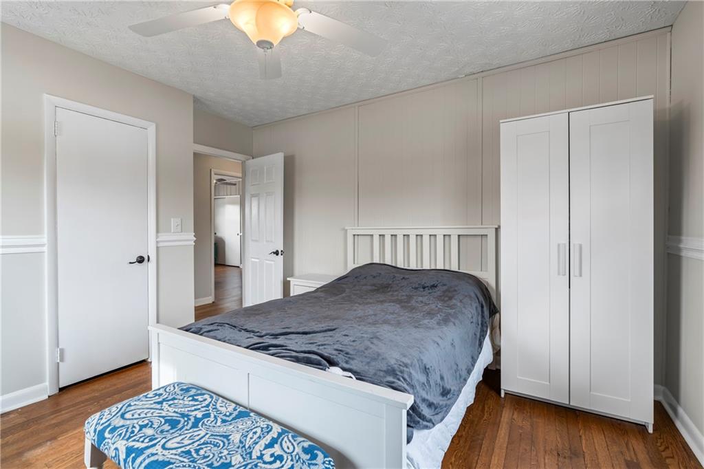 2150 Smyrna Ridge Court Southwest Conyers, GA 30094 - Photo 73 of 125 a bedroom with a bed and a chandelier