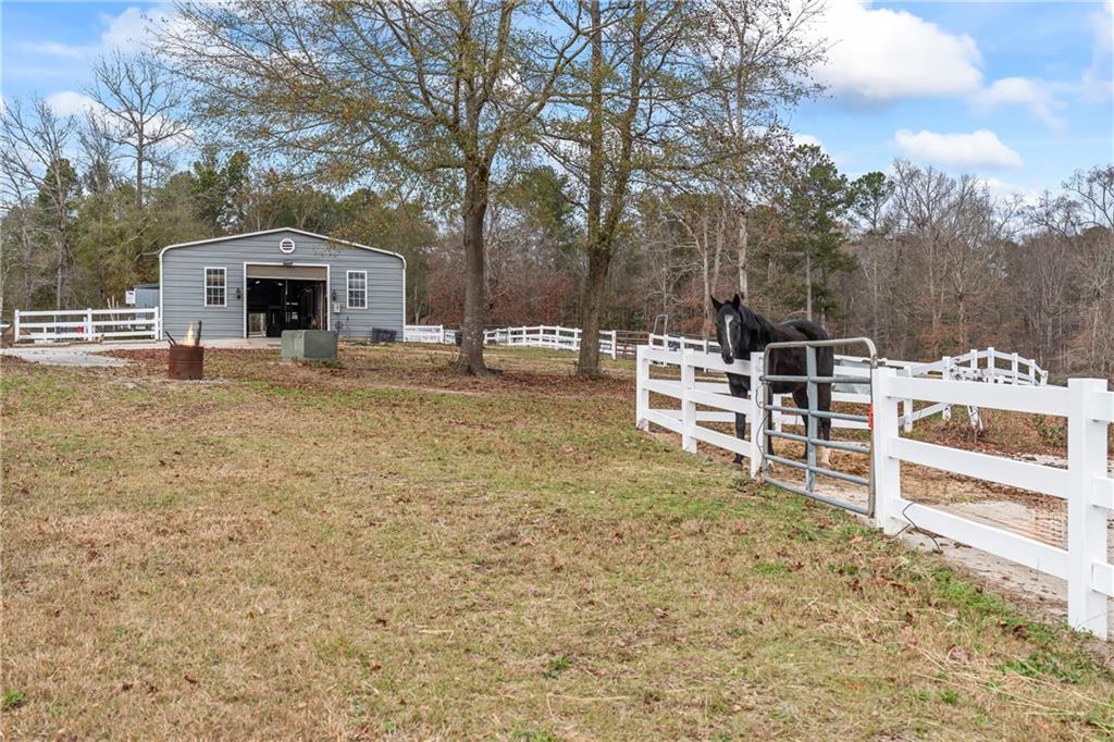 2150 Smyrna Ridge Court Southwest Conyers, GA 30094 - Photo 78 of 125 a view of a house with a yard and sitting area