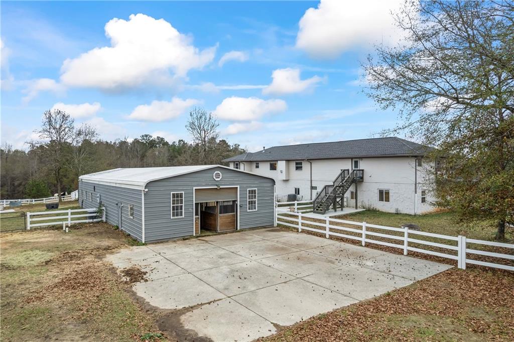 2150 Smyrna Ridge Court Southwest Conyers, GA 30094 - Photo 95 of 125 a view of a house with a yard and wooden fence