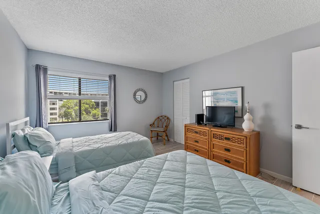 a bedroom with a bed and chair