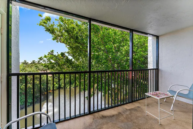 a view of a chair and tables in the balcony