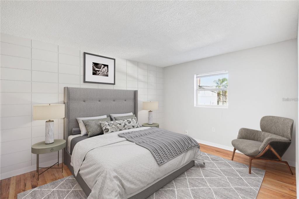 320 Lakeview Street, Unit 213 Orlando, FL 32804 - Photo 15 of 24 a bedroom with a bed and chair