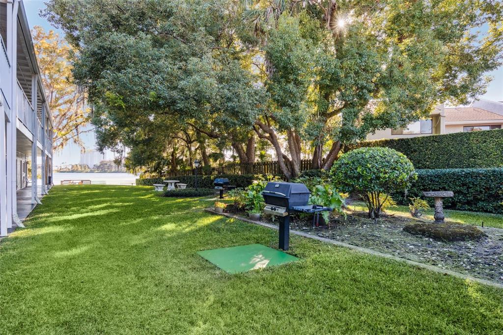 320 Lakeview Street, Unit 213 Orlando, FL 32804 - Photo 22 of 24 a view of a garden with a bench and some trees
