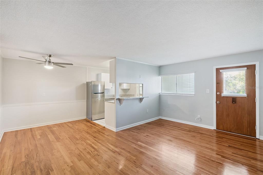 320 Lakeview Street, Unit 213 Orlando, FL 32804 - Photo 5 of 24 a view of empty room with wooden floor and window