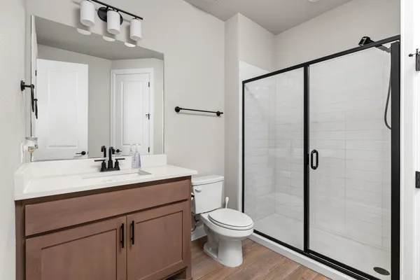 a bedroom with a bed table and window