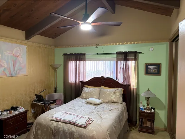 a bedroom with a bed and a large mirror