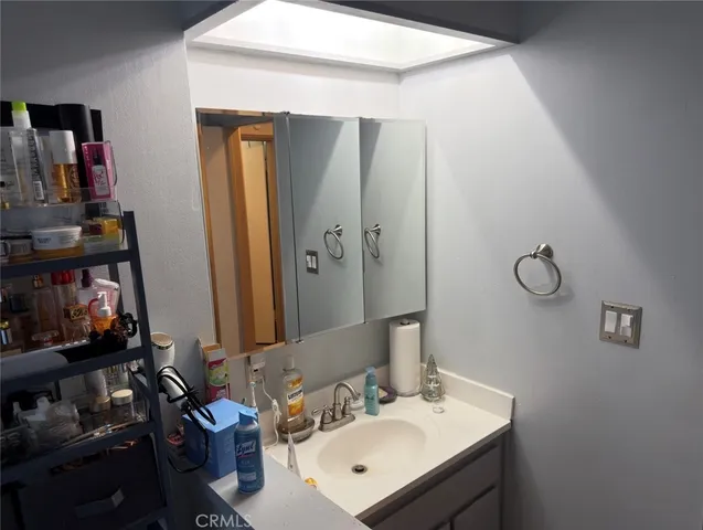 a kitchen with a sink dishwasher and a dining table with chairs