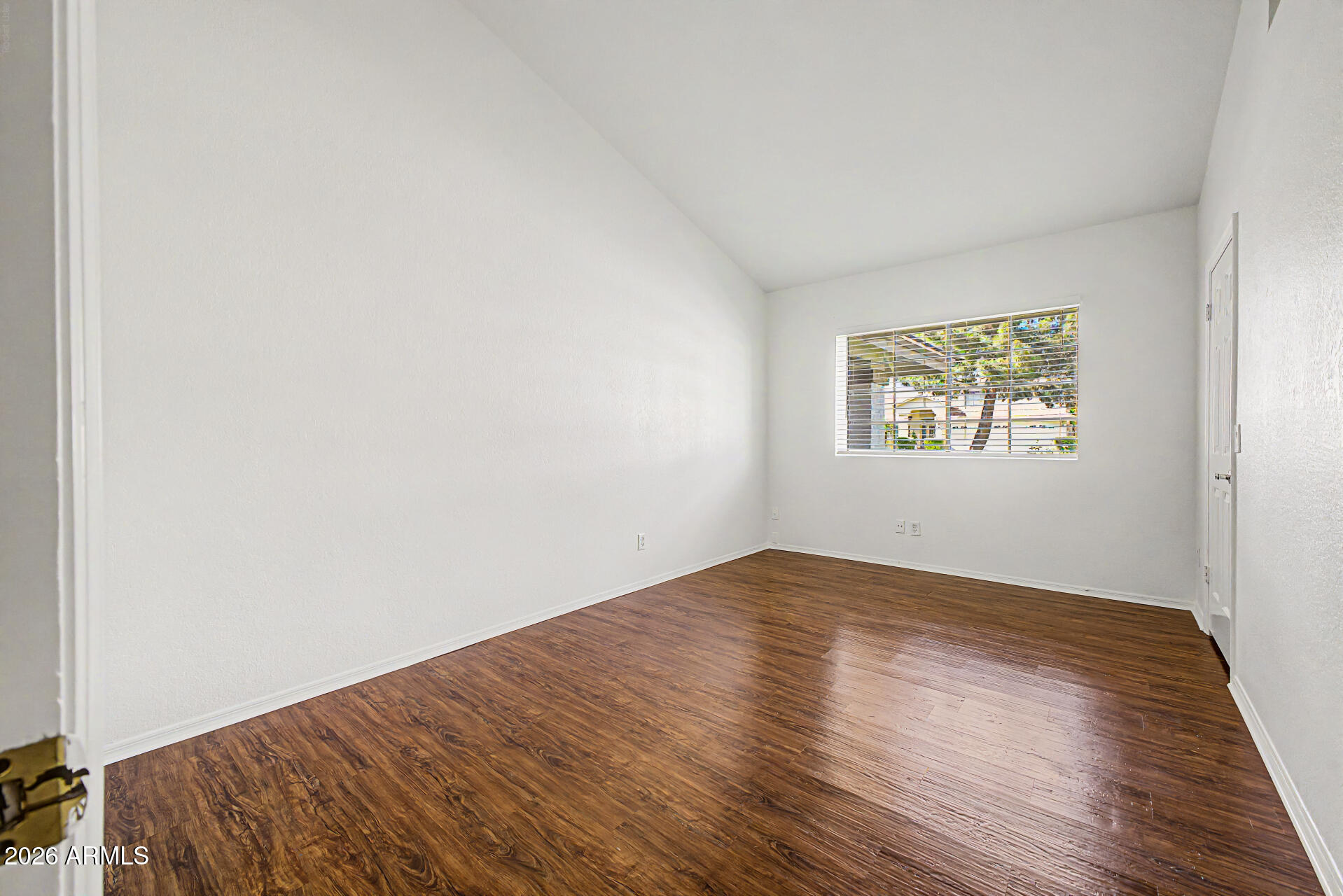 6725 West Utopia Road Glendale, AZ 85308 - Photo 17 of 27 an empty room with wooden floor and windows